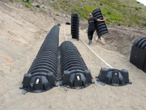 Manual installation of septic chambers for a uniform distribution sand mound system in a wildfire recovery zone in the Okanagan.
