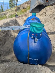Installation of a large capacity, Canadian-made fiberglass septic tank for a multi-unit Type 2 system on a steep hillside property in the Okanagan