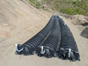 Completed layout of three parallel rows of infiltrator septic chambers on a sand mound system, demonstrating precise uniform distribution in a wildfire recovery zone.